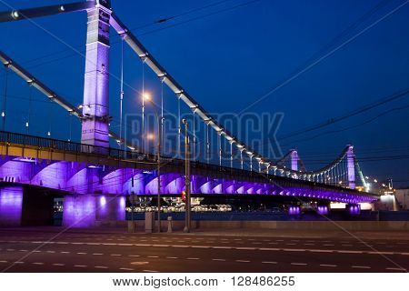 Illuminated Krymsky (Crimean) bridge over Moscow river at night.