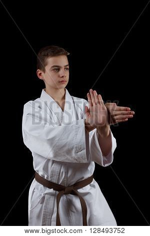 Karate Fighter in white Kimono Isolated on Black with Copyspace