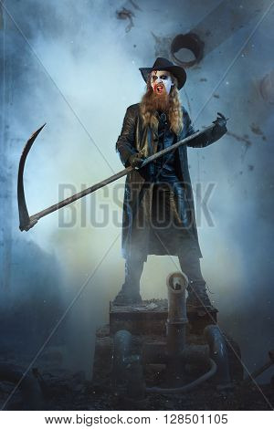 Horrible man brandishing a scythe and shouts.