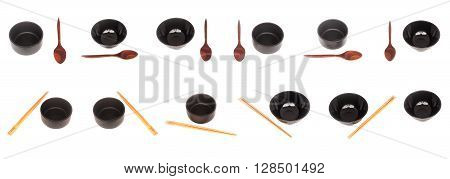 Black ceramic bowl with wooden shopsticks and spoon isolated on white background