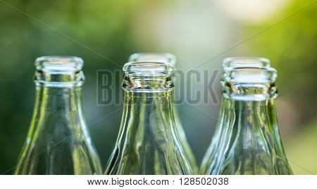 Glass Bottles Over The Sunny Background