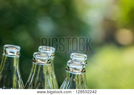 Glass Bottles Over The Sunny Background