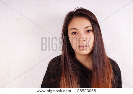 crying young asian woman with tears running down her cheeks