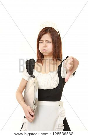 young Japanese woman wearing french maid costume with thumbs down gesture