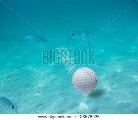 a golf ball underwater in a blue lake