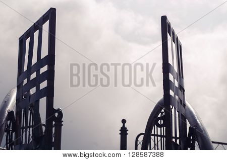 Metal gate with simple decorations sorrounded by misty and foggy spectacular mountain view in Quito Ecuador.