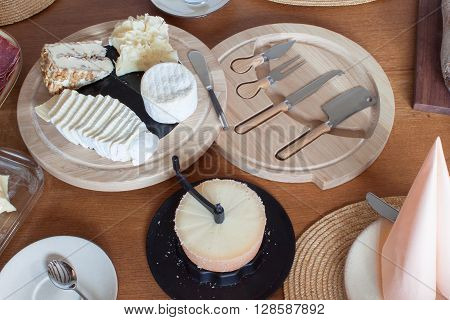 Different types of cheese on the table. Homework healthy breakfast. Diet food. Breakfast for children. Well-laid wooden table.