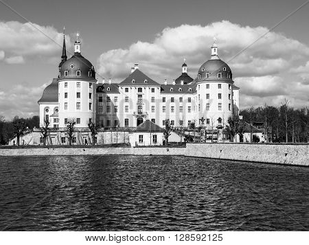 Baroque castle of Moritzburg with yellow facade and red roof on sunny day, Saxony, Germany. Black and white image.