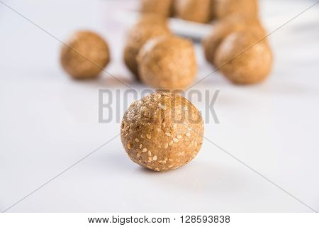 isolated tilgul laddu or laddoo or til gul laddu, showing texture on white background, top view closeup