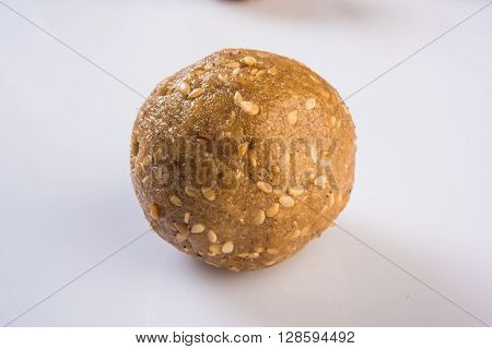 isolated tilgul laddu or laddoo or til gul laddu, showing texture on white background, top view closeup