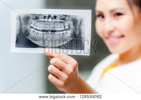 Dentist looking at x-ray picture in the office