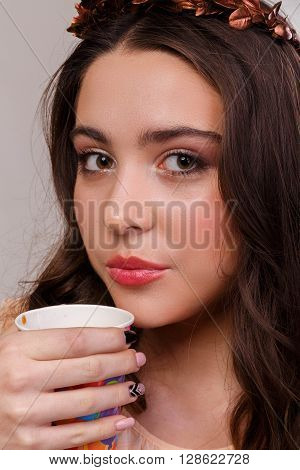 Portrait of a gorgeous brunette on a light background. Chic hair eyes and eyebrows.