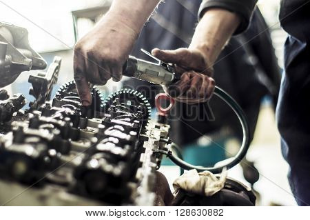 Hands Repairing A Car Engine With A Wrench