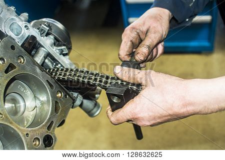 Hands Repairing A Car Engine With A Wrench
