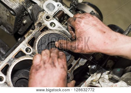Hands Repairing A Car Engine With A Wrench