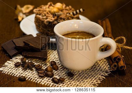 Espresso coffee on a wooden table, beans, chocolate, cinnamon, warm white Ballance
