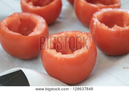preparing tomatoes stuffed with rice with the removal of the pulp and the seeds