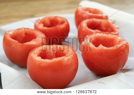 preparing tomatoes stuffed with rice with the removal of the pulp and the seeds