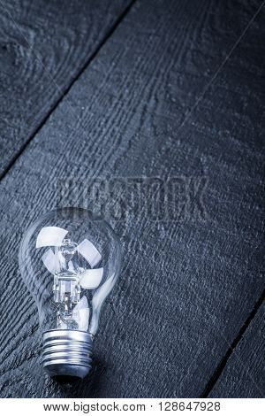 Tungsten bulb on a black wooden table
