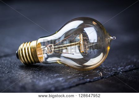 Tungsten bulb on a black wooden table