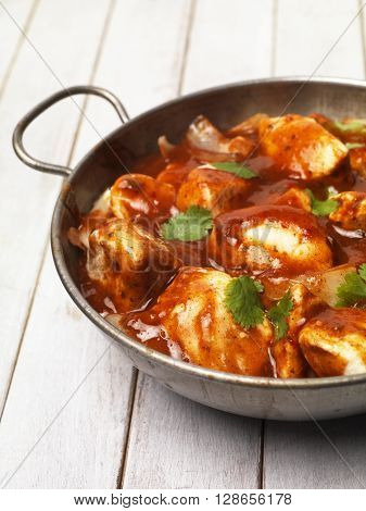 Chicken Curry on a table top in a balti bowl