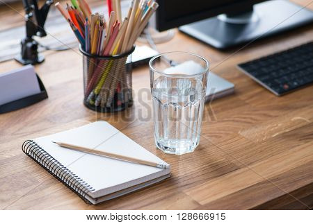 Light And Cozy Workplace With Glass Of Water