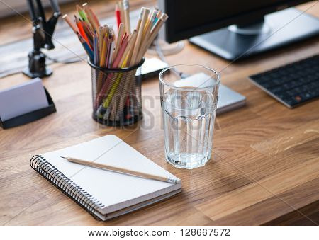 Light And Cozy Workplace With Glass Of Water