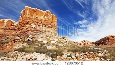 layered sandstone rock formation in a desert landscape