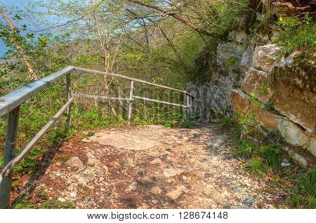 Mountain trail with fence along steep wall HDR processing