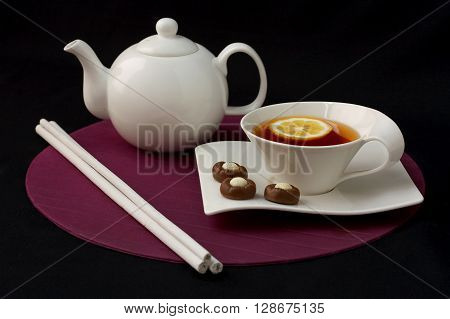 Cup of tea with lemon and sweets