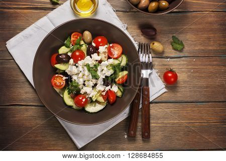 Traditional greek salad with fresh vegetables, feta cheese and olives. Top view. Rustic style. Selective focus