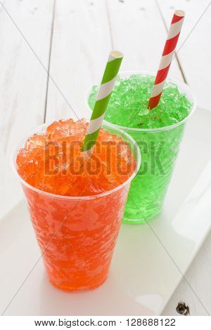 Fresh colorful summer slushies on white wood