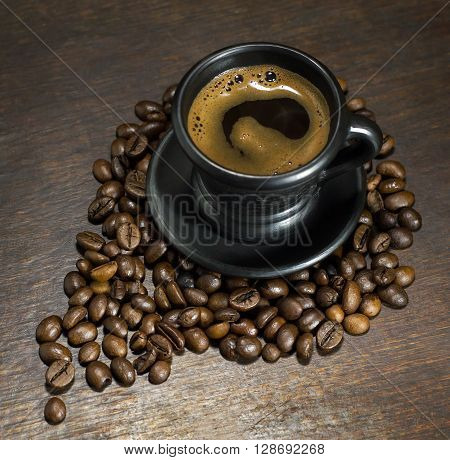 A cup of hot coffee on wooden background