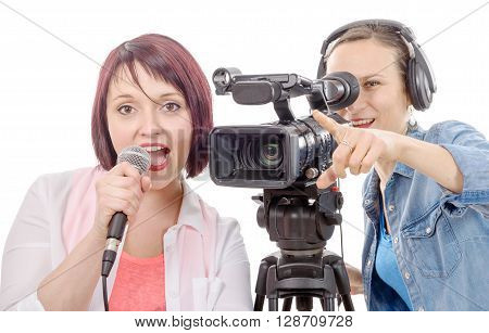 a young woman journalist with a microphone and camerawoman