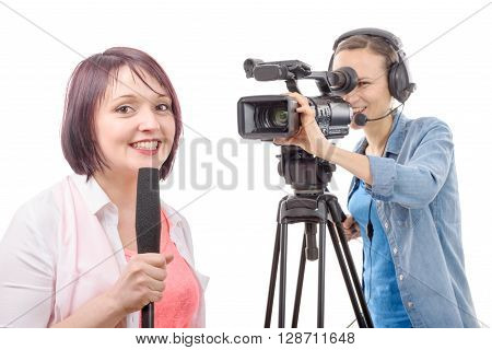 a young woman journalist with a microphone and camerawoman