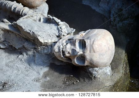 skull and skeleton of long time ago dead men in the ruins of Ercolano Italy