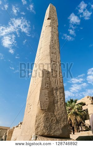 big obelisk with carving figures and hieroglyphs in landmark Egyptian Karnak Temple public ancient monument declared a World Heritage by Unesco in Luxor Egypt Africa