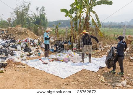 PAI, THAILAND - April 10, 2016 : Councils officer prepare Screeners in the garbage disposal pond in Pai,Thailand