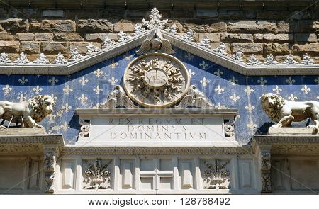 FLORENCE, ITALY - JUNE 05: Medallion with the IHS monogram between two lions, above to the entrance to Palazzo Vecchio, a UNESCO World Heritage Site in Florence, Italy, on June 05, 2015