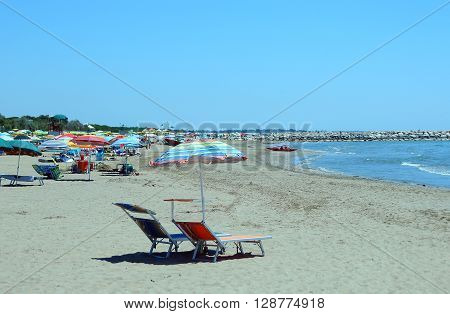 Hot Summer. Sun Umbrellas And Sun Beds For Relaxation
