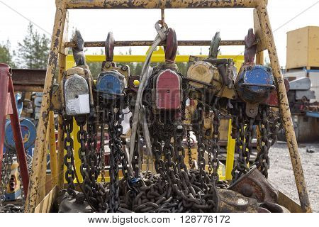 Electrical block and tackles with chains and hooks haning on a scaffolding