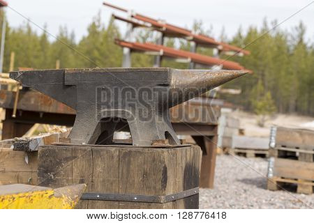 A huge anvil on a wood pole