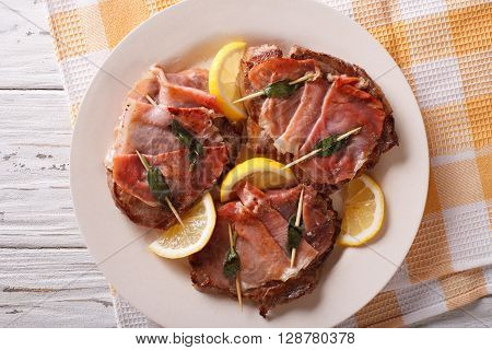 Italian Beef Saltimbocca With Sage, Ham And Lemon Close-up. Horizontal Top View