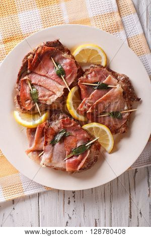 Italian Beef Saltimbocca With Sage, Ham And Lemon Close-up. Vertical Top View
