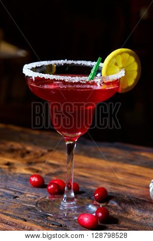 Cosmopolitan cocktail top on bar, cocktail made with vodka, triple sec, cranberry juice, and freshly squeezed lime juice or sweetened lime juice.