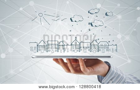 Hand of businessman demostrating tablet and construction concept on screen