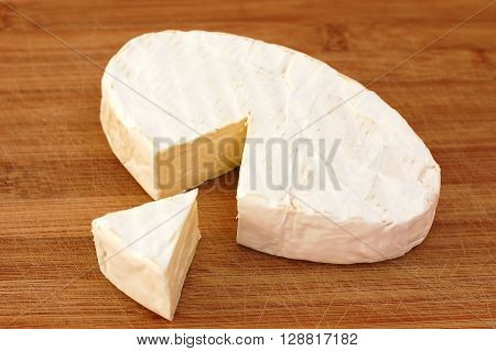 Cheese Camembert On The Brown Wooden Background