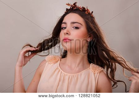 Portrait of a gorgeous brunette on a light background. Chic hair eyes and eyebrows.