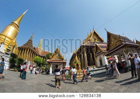 BANGKOK THAILAND - JANUARY 24 2015: Unidentified tourists at Wat Phra Kaew in Bangkok Thailand. Wat Phra Kaew is one of the most popular tourists destination in Thailand.