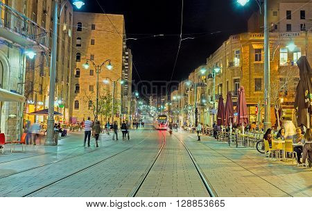 JERUSALEM ISRAEL - FEBRUARY 17 2016: The evening makes the Jaffa Road best place to spend the time in cozy outdoor cafe or restaurant of local cuisine on February 17 in Jerusalem.